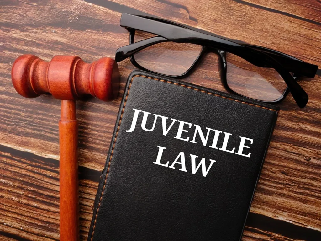 Book of Juvenile Law and glasses on a desk.