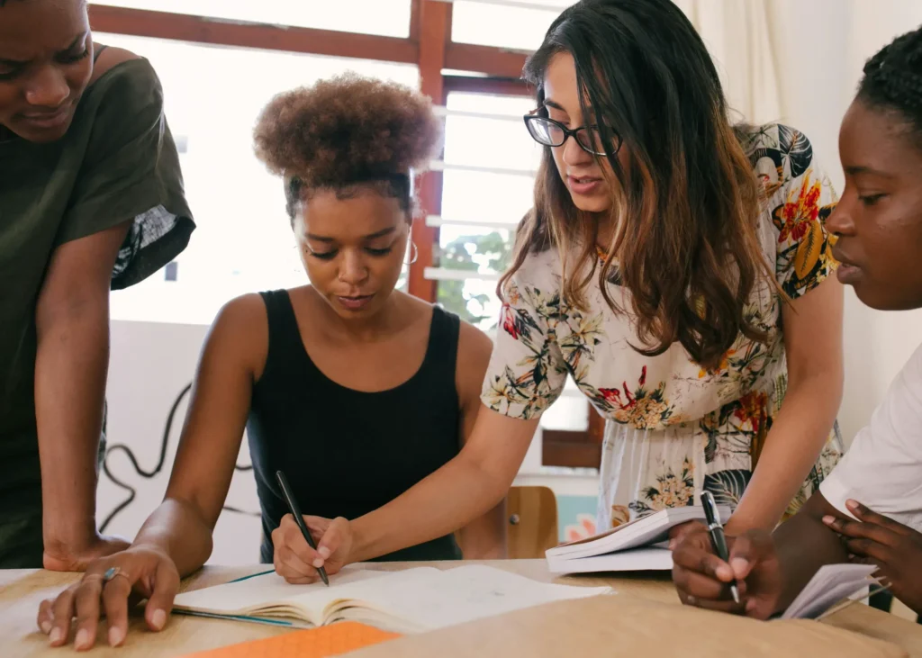 A group of students looking at documents on a table.