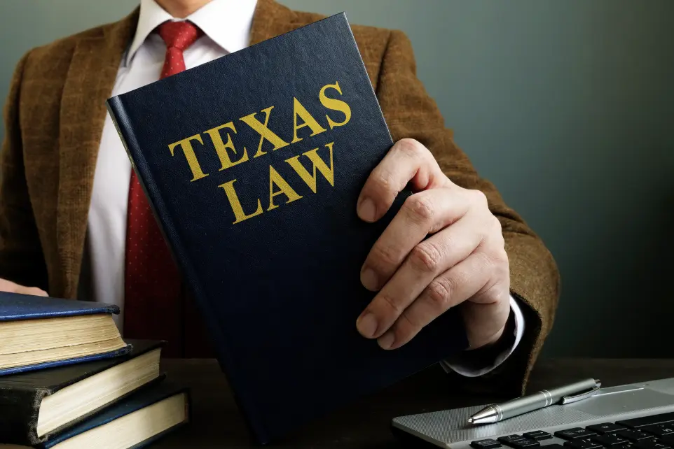 Lawyer showing a Texas Law book